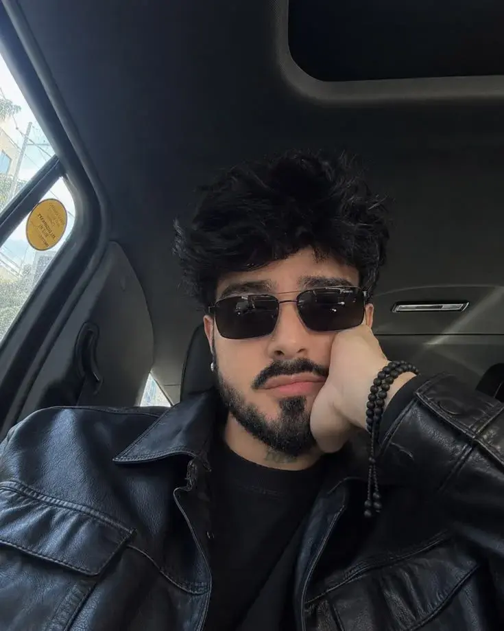 A Close-Up Photo Of A Man Sitting In The Back Seat Of A Car,