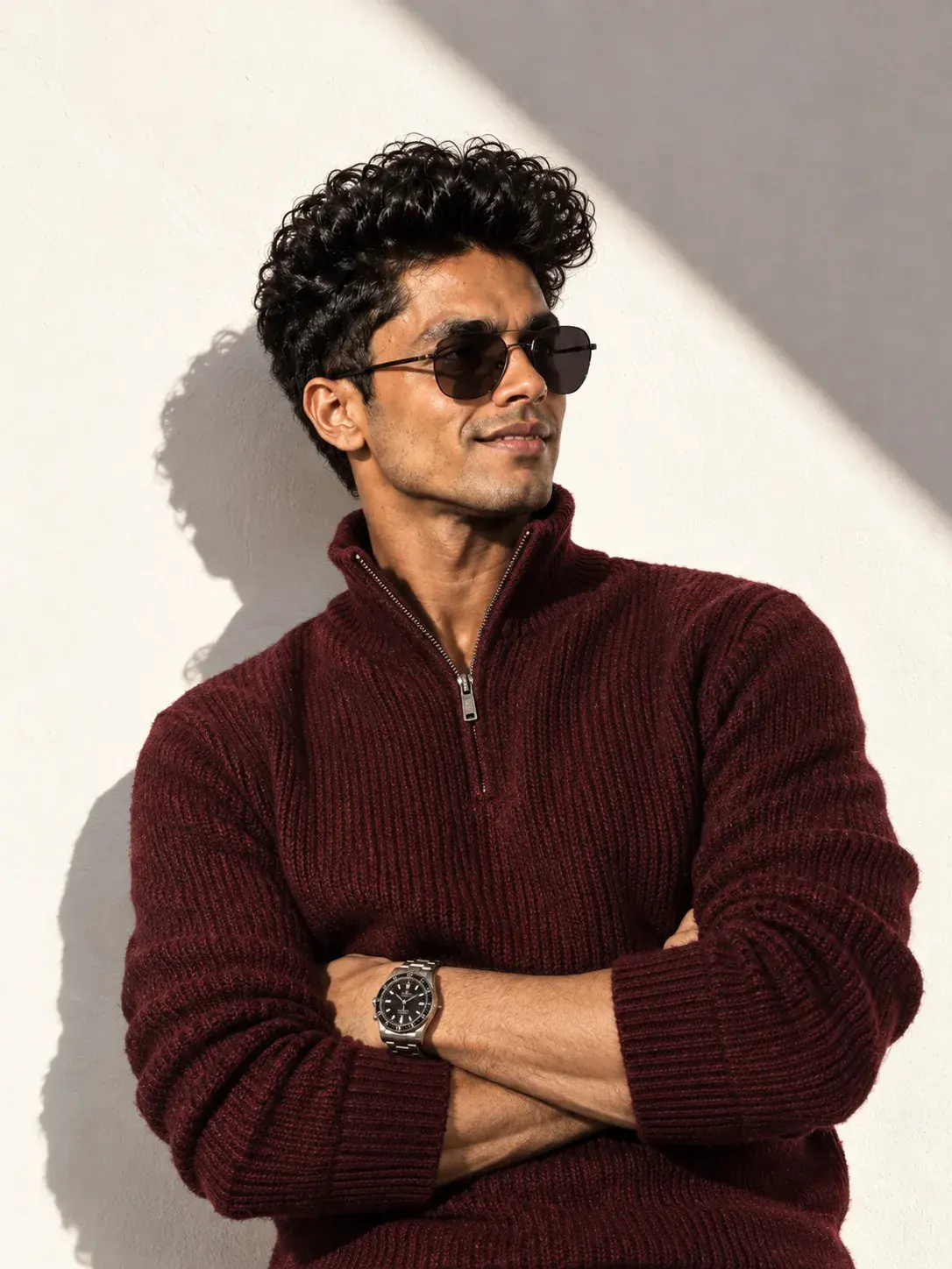 A Man Smiling And Posing With His Arms Crossed