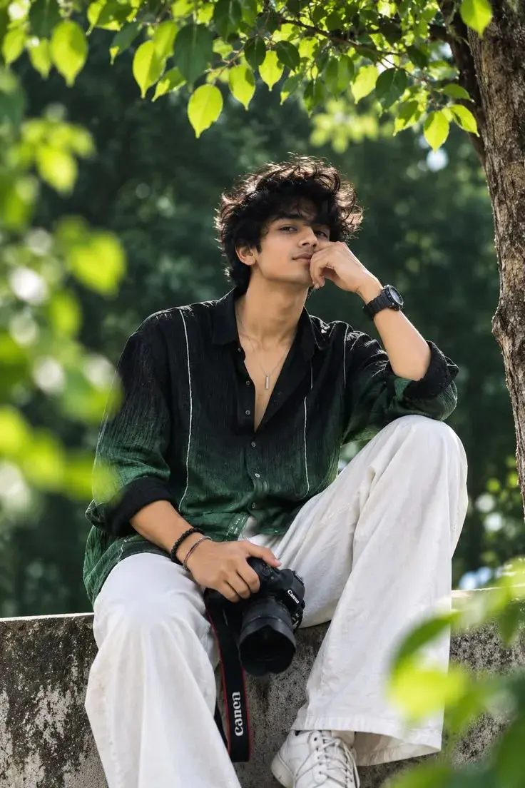 A Young Man Sitting On A Stone Bench Garden