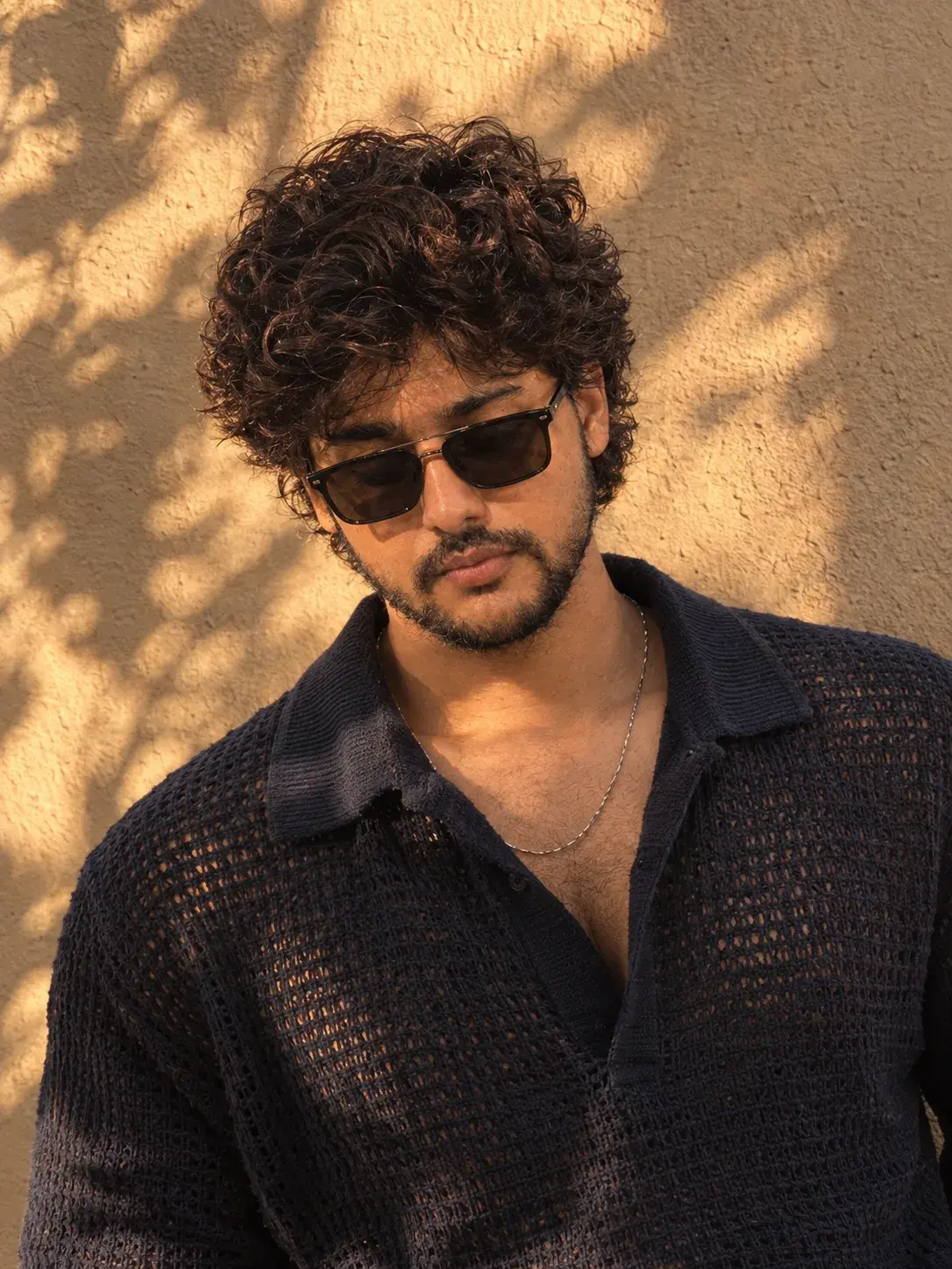 A Young Man With Thick Tousled Black Hair