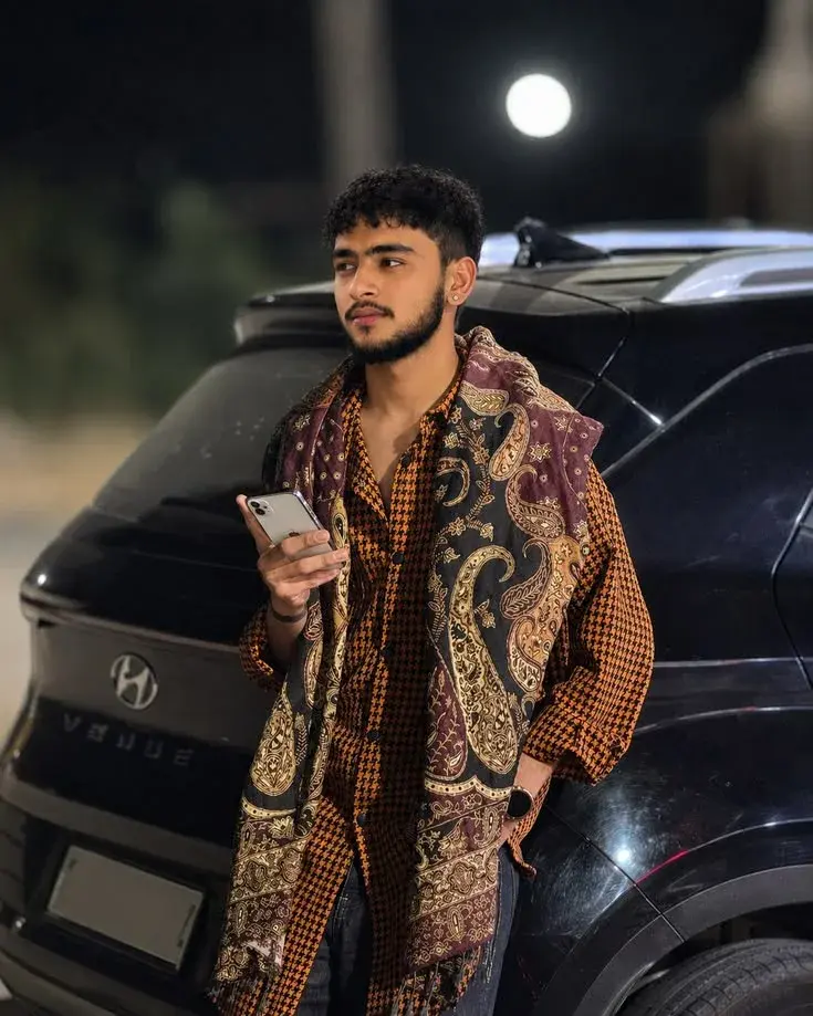 Black Hyundai Car, Holding A Cell Phone In His Right Hand