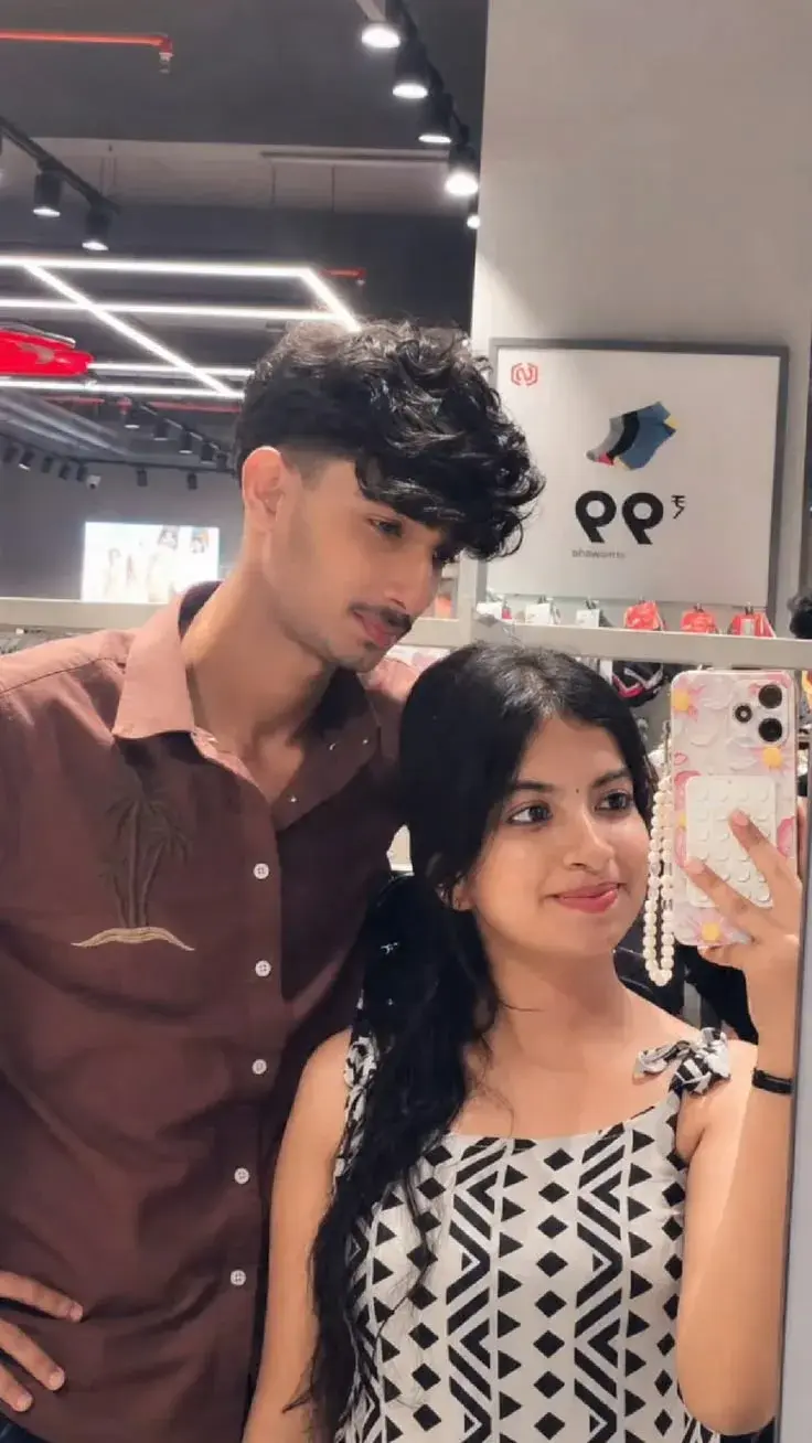 Candid Couple Mirror Selfie In Modern Clothing Store