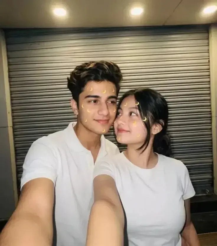 Candid Front-Facing Couple Selfie With Yellow Crescent Moon AR Filter In White Shirts
