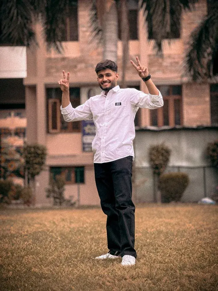Candid Full-Length Outdoor Campus Portrait Of Young Man Flashing Peace Signs