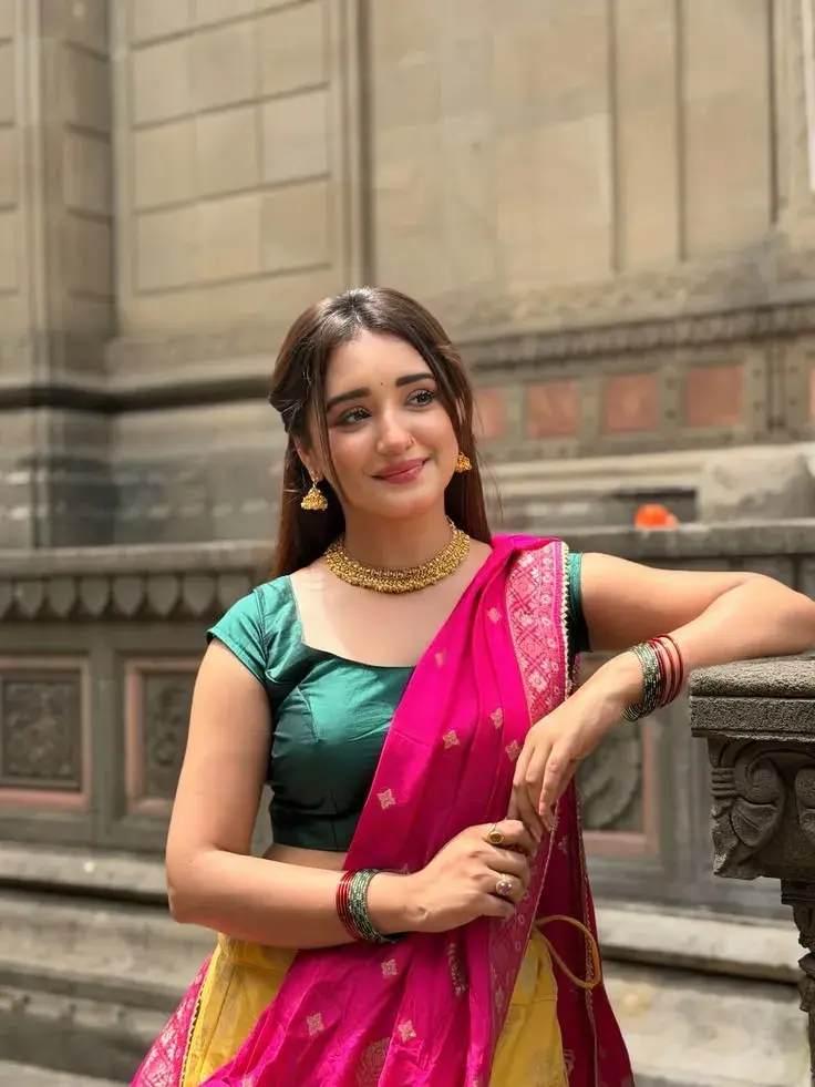 Candid Heritage Architecture Portrait Of Radiant Young South Asian Woman In Hot Pink Saree And Emerald Green Blouse Lean