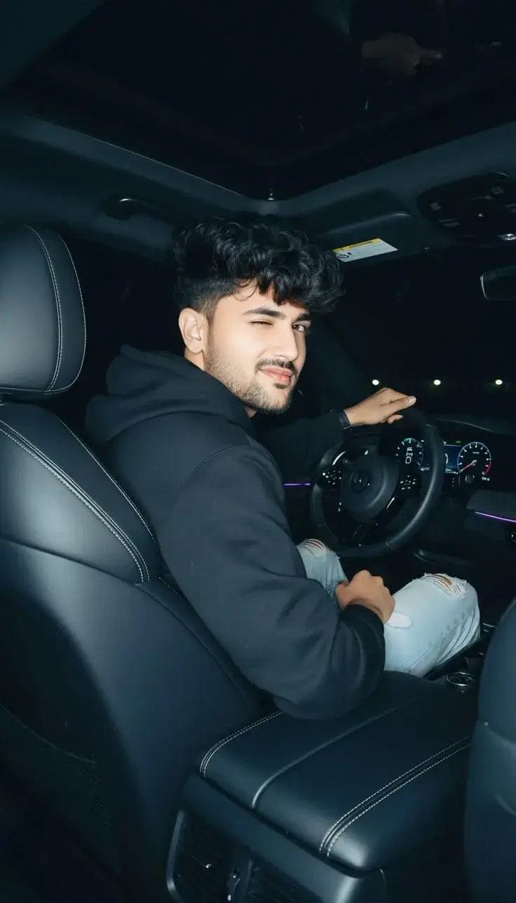 Candid Night Car Interior Portrait Of Handsome Young South Asian Man Winking From Driver Seat
