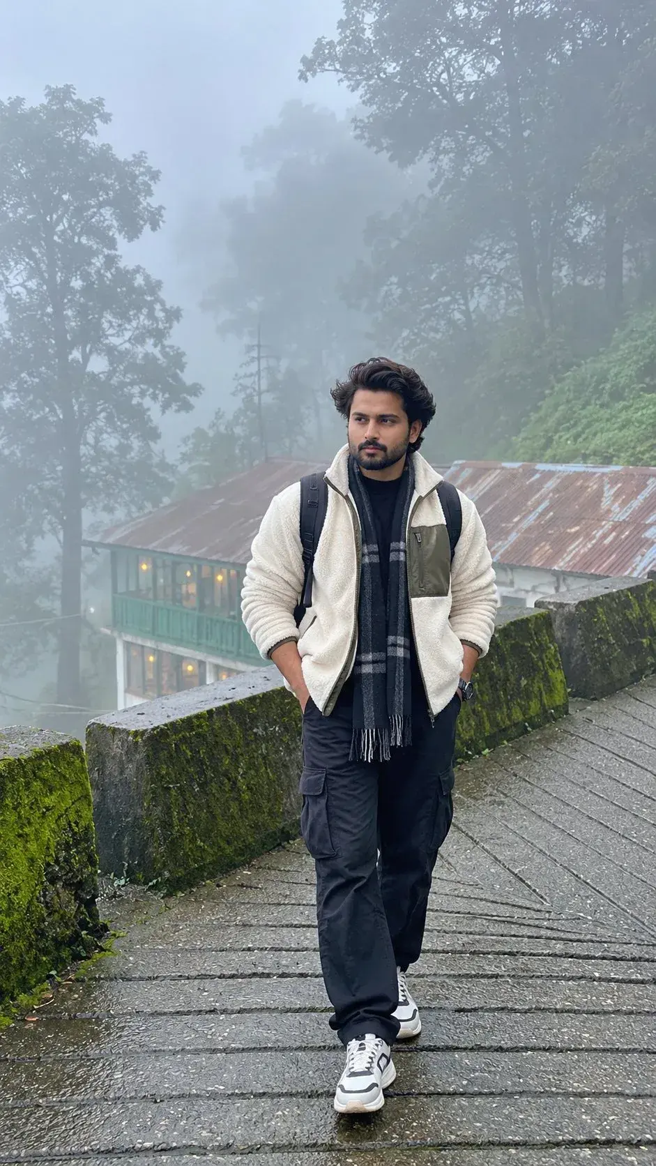 Candid Outdoor Foggy Hill Station Full-Length Portrait Of Young South Asian Man In Fleece Jacket And Plaid Scarf Walking