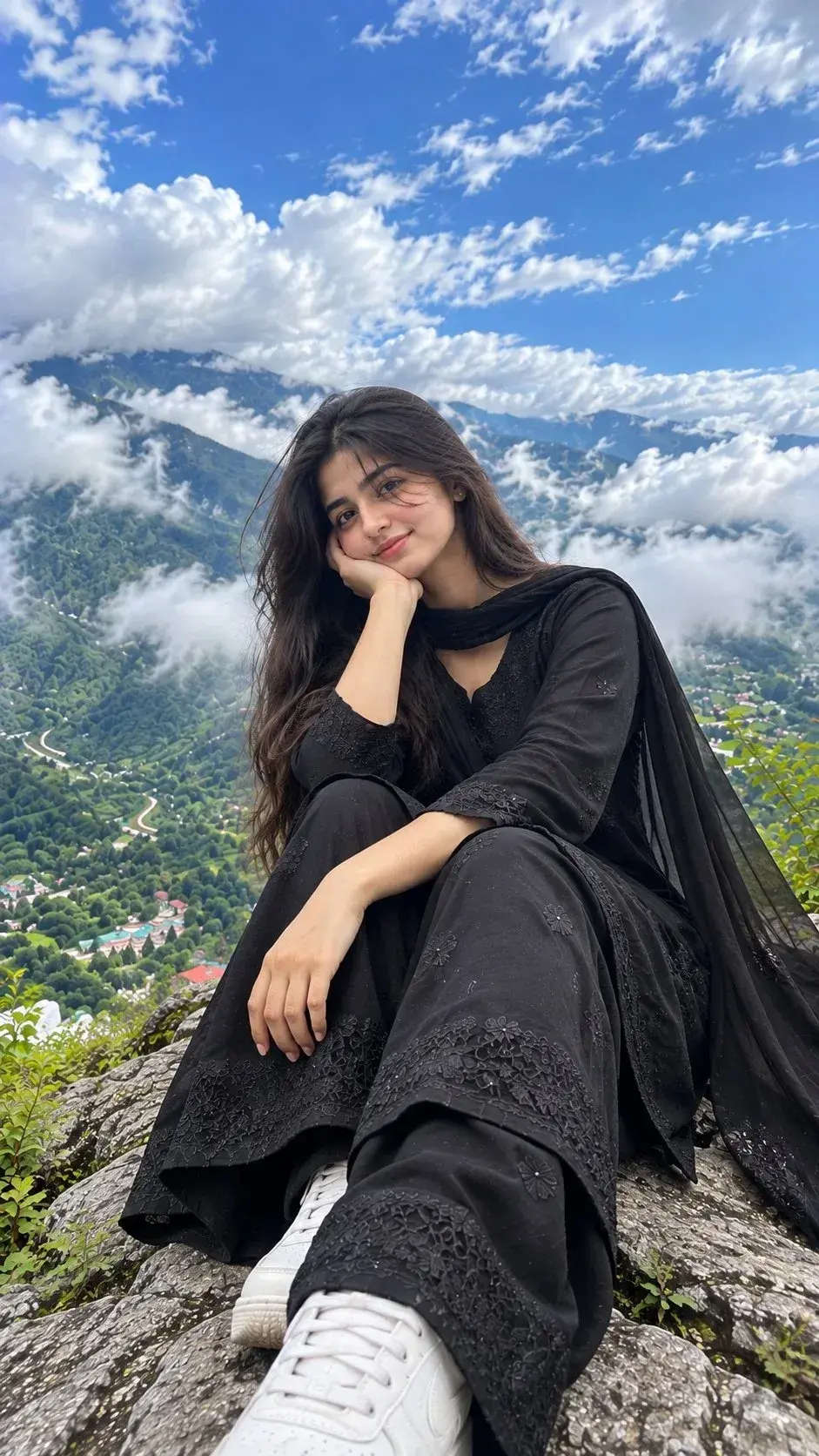 Candid Outdoor Mountain Summit Portrait Of Smiling Young South Asian Woman In Black Embroidered Salwar Kameez On Rocky P