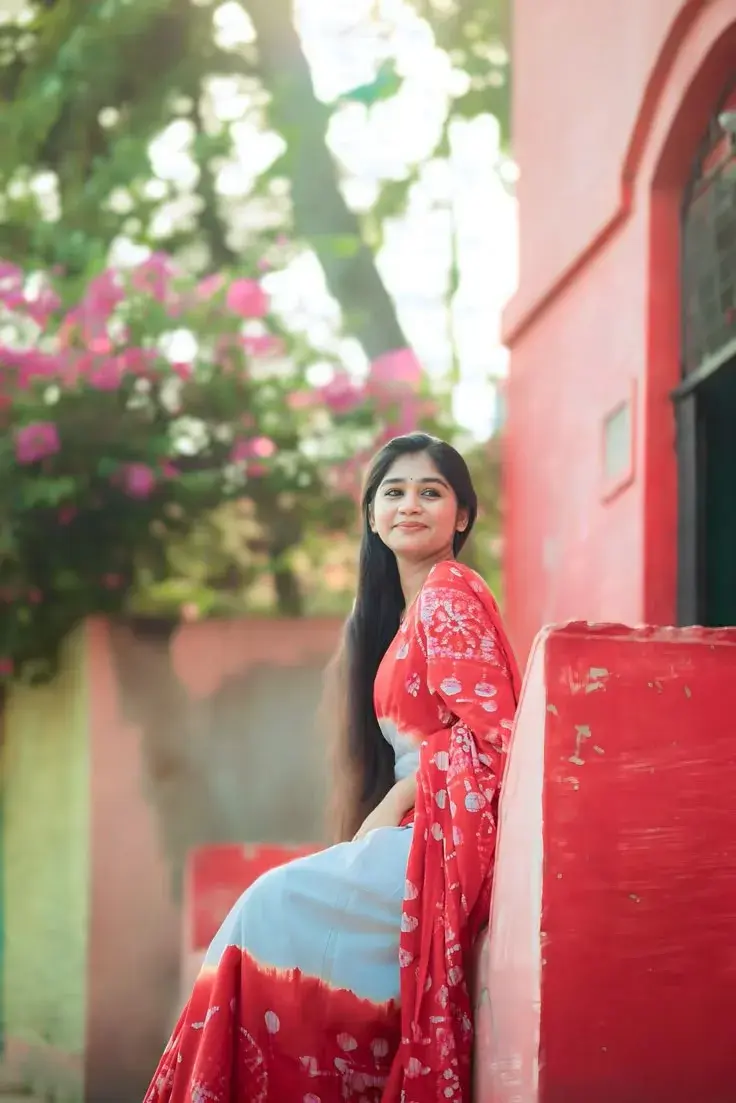 Candid Outdoor Portrait In Red Batik Saree By Coral Wall