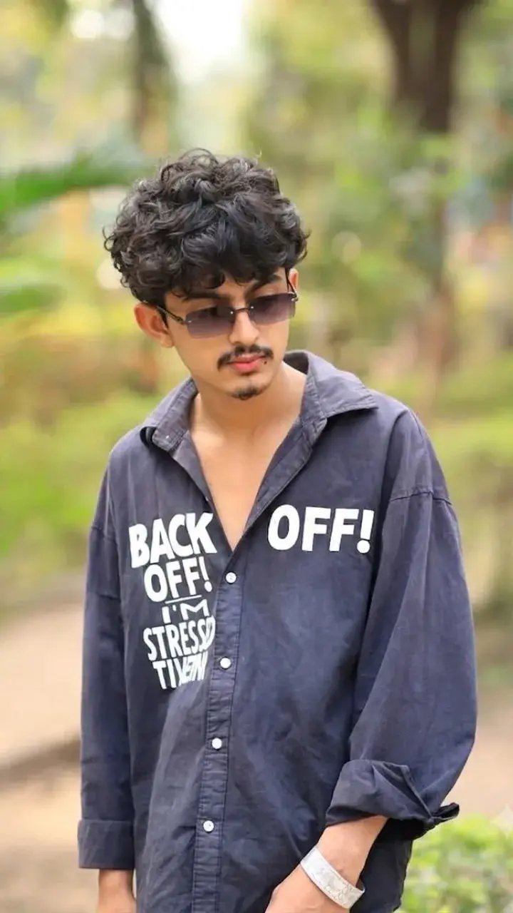 Candid Outdoor Portrait Of Young Indian Man In Graphic Button-Down Shirt