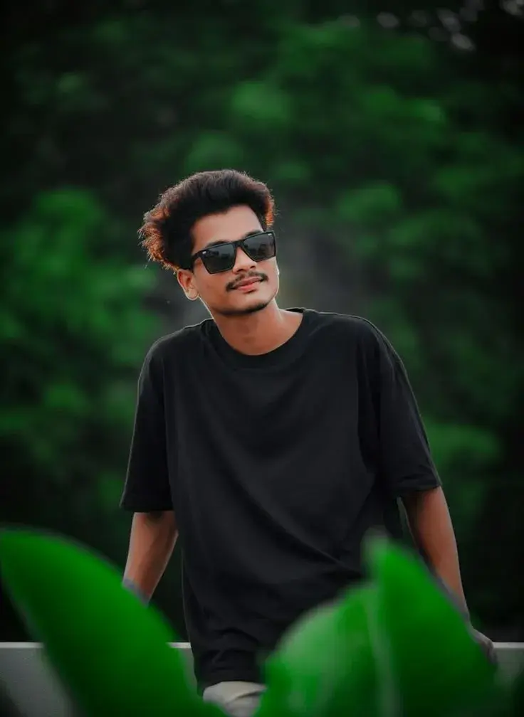 Candid Outdoor Portrait Of Young Indian Man In Oversized Black T-Shirt
