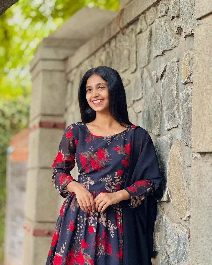 Candid Outdoor Portrait Of Young Woman By Rustic Stone Wall
