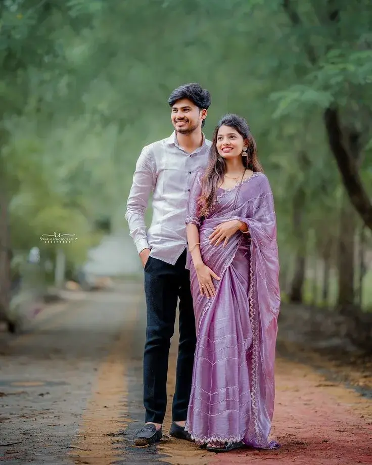 Candid Outdoor Pre-Wedding Portrait Of Indian Couple On Tree-Lined Pathway