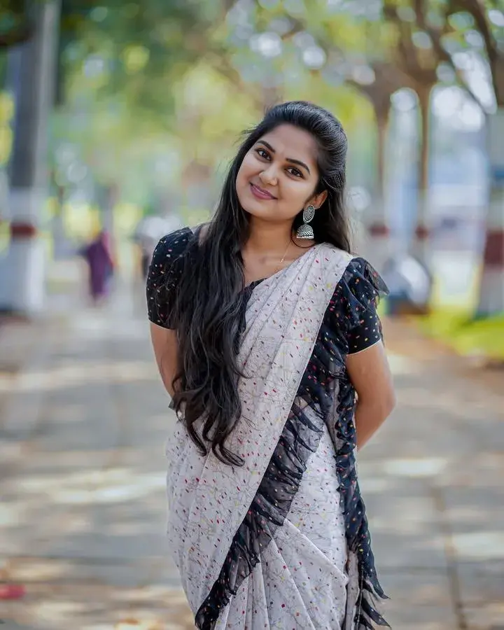 Candid Outdoor Promenade Portrait Of Smiling Young South Asian Woman In Printed Saree With Ruffled Border