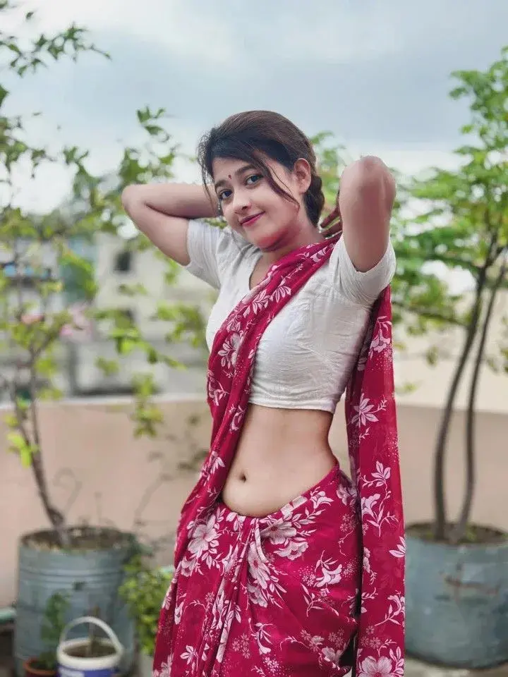 Candid Outdoor Rooftop Portrait Of Young Indian Woman In Floral Saree