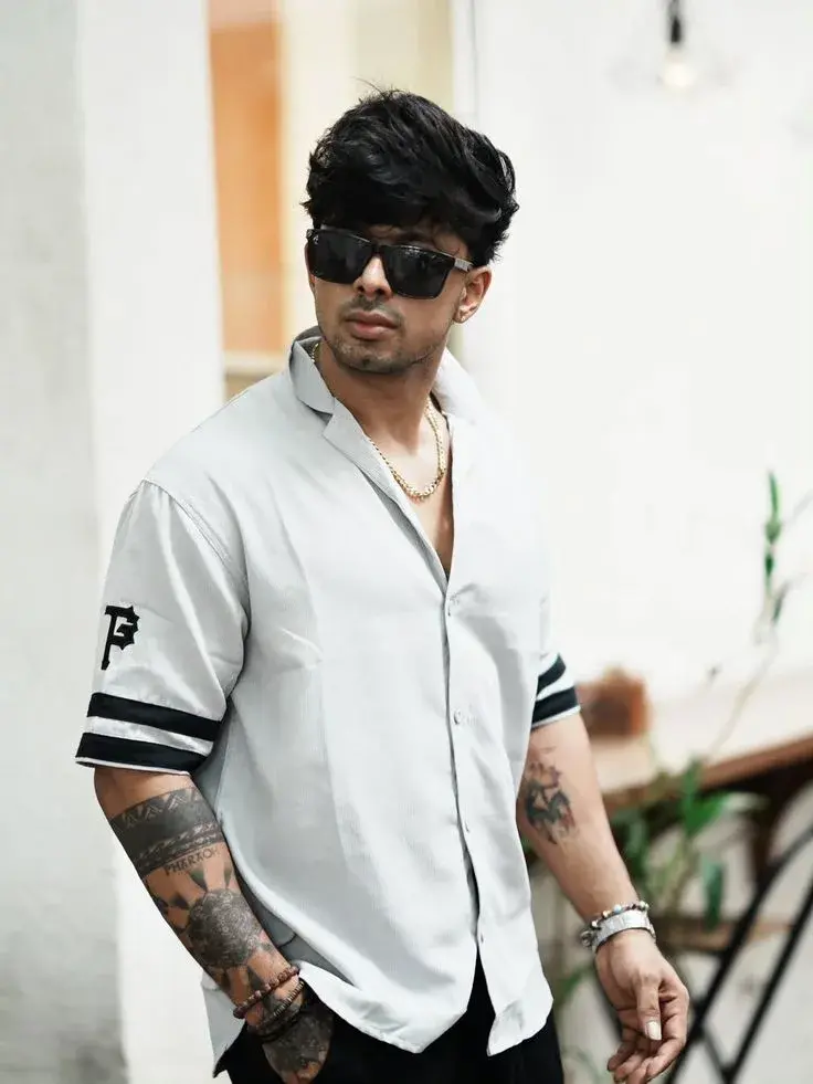 Candid Outdoor Street Portrait Of Muscular Young South Asian Man In Pale Grey Baseball Shirt And Sunglasses