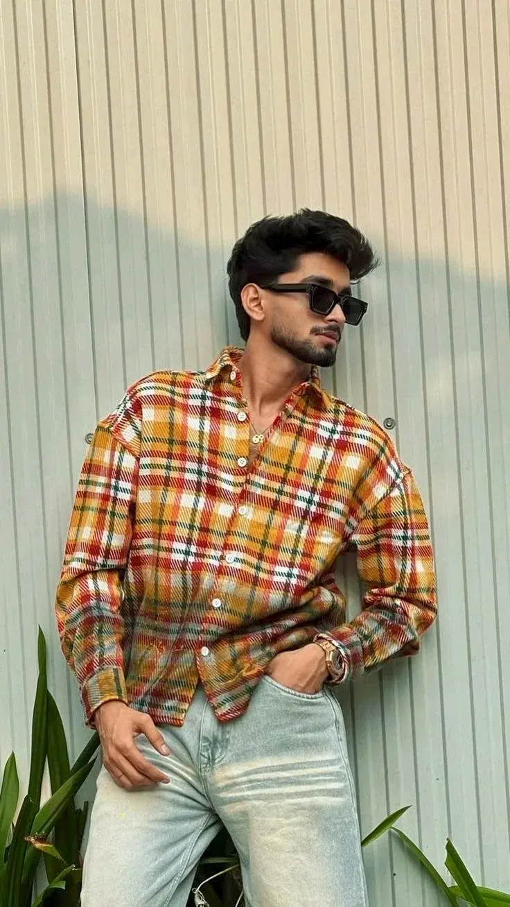 Candid Outdoor Streetwear Portrait Of Handsome Young South Asian Man In Yellow Plaid Overshirt And Rectangular Sunglasse