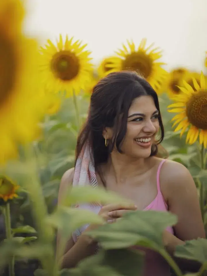 Candid Outdoor Sunflower Field Portrait Of Smiling Young South Asian Woman In Pink Camisole