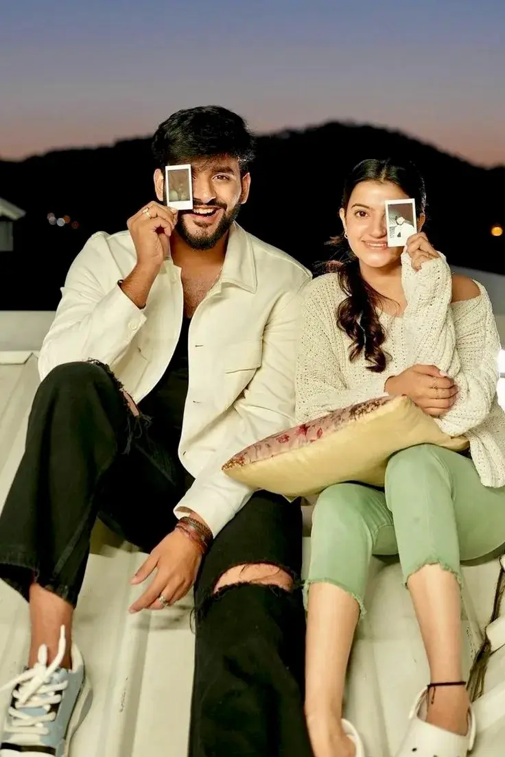 Candid Rooftop Sunset Portrait Of Smiling South Asian Couple Holding Polaroid Photos Over Their Eyes