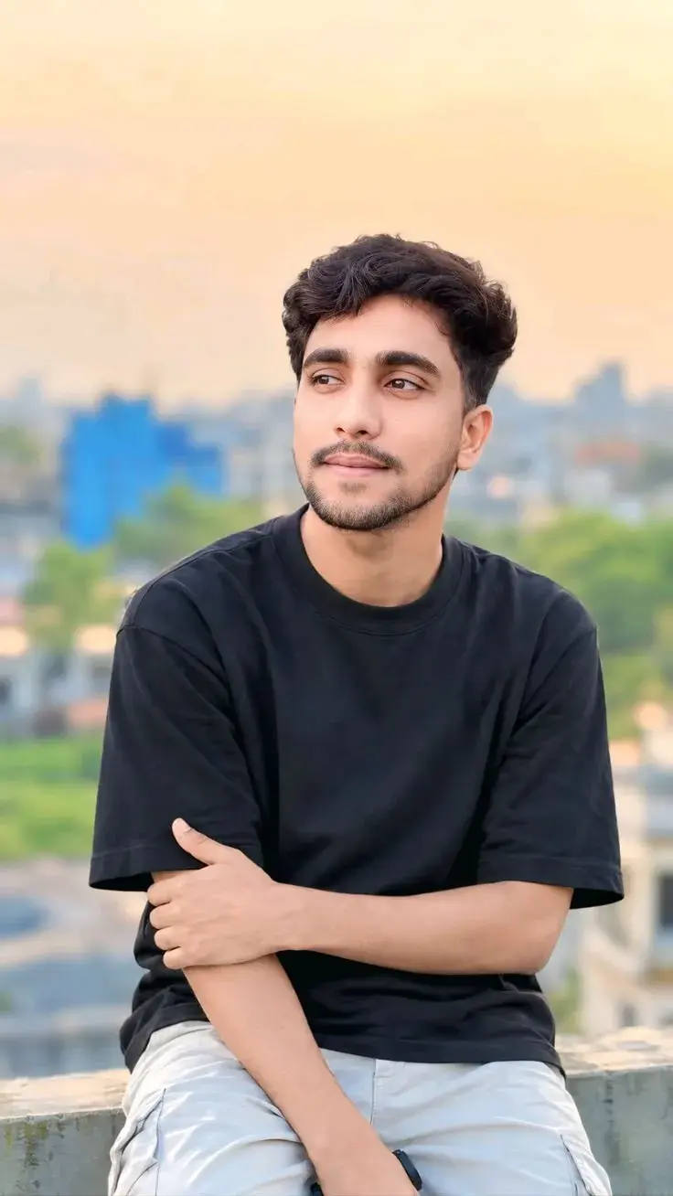 Candid Rooftop Sunset Portrait Of Young Indian Man In Oversized Black T-Shirt