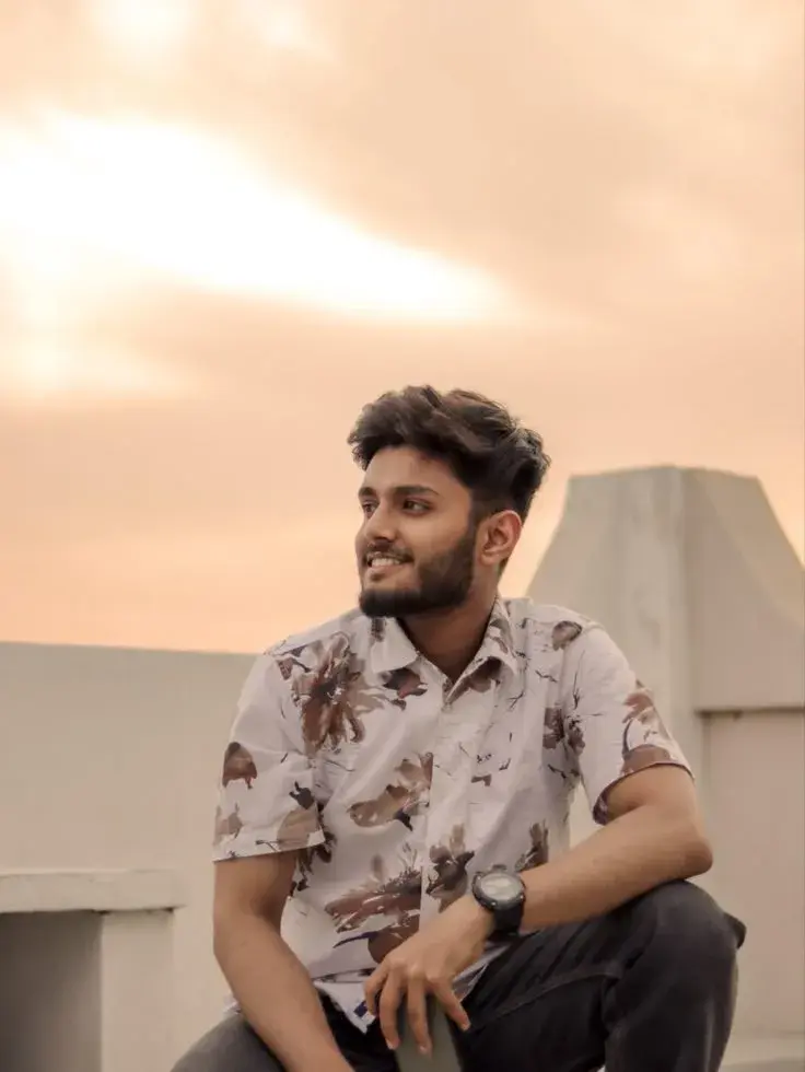 Candid Rooftop Sunset Portrait Of Young South Asian Man In Floral Shirt