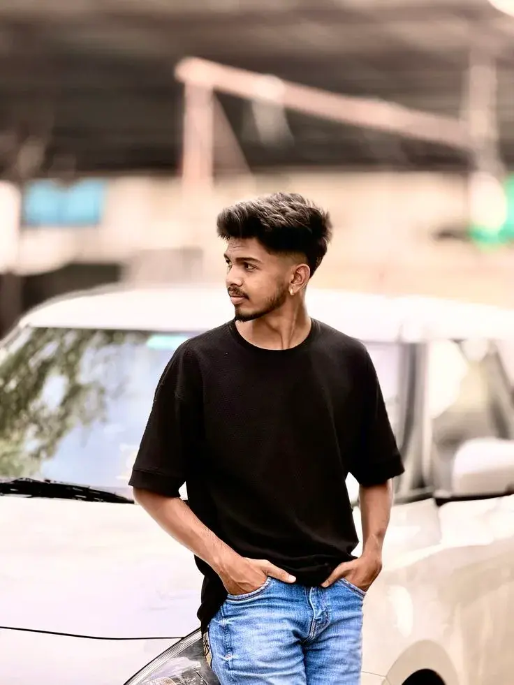 Candid Street Portrait Of Young Man Leaning On White Car