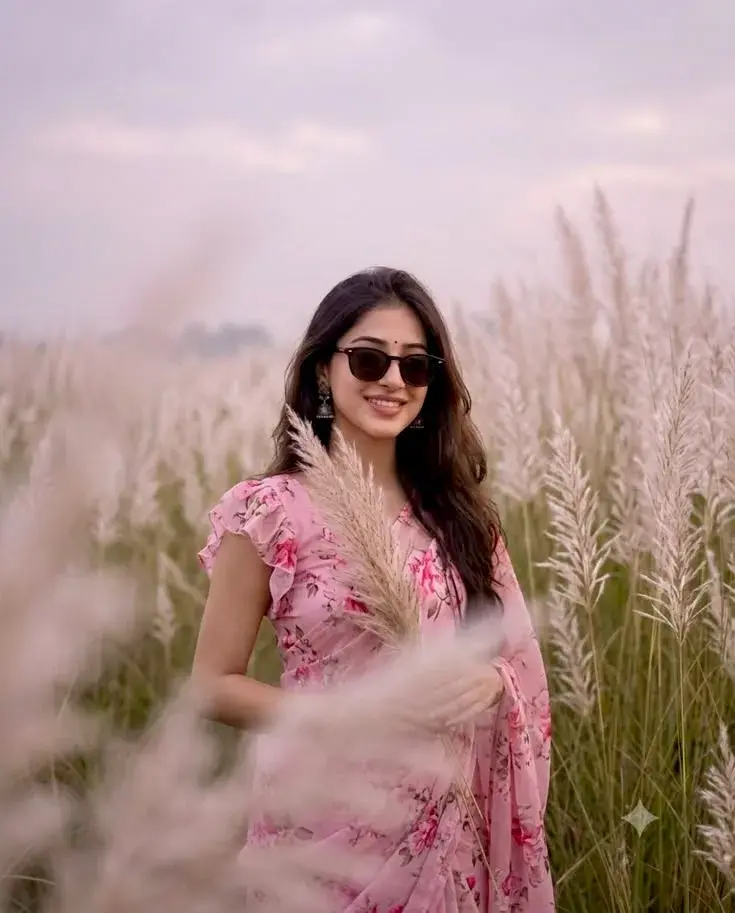 Candid Sunlit Kashful Grassland Portrait Of Smiling Young South Asian Woman With Sunglasses In Pink Floral Saree