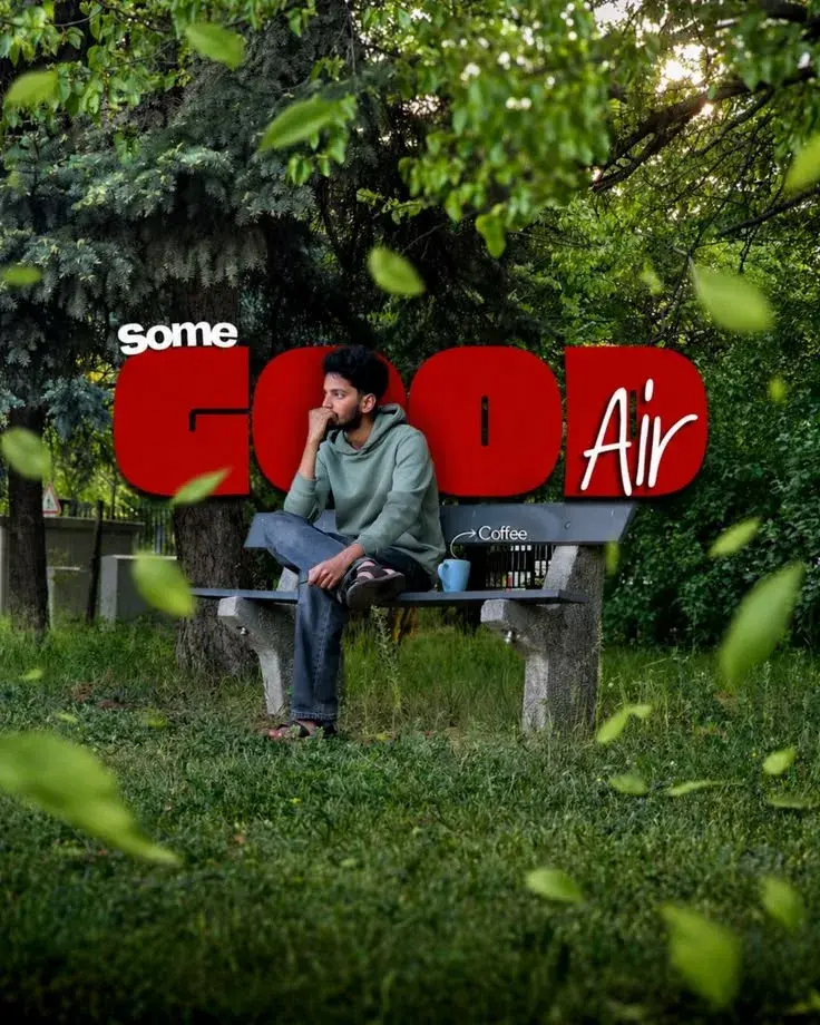 Candid Sunlit Park Bench Portrait Of Pensive Young South Asian Man In Sage Hoodie With Graphic 