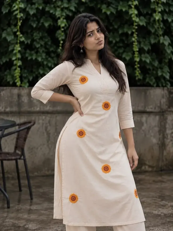 Candid Woman In Cream Sunflower-Embroidered Kurta Posing Outdoors