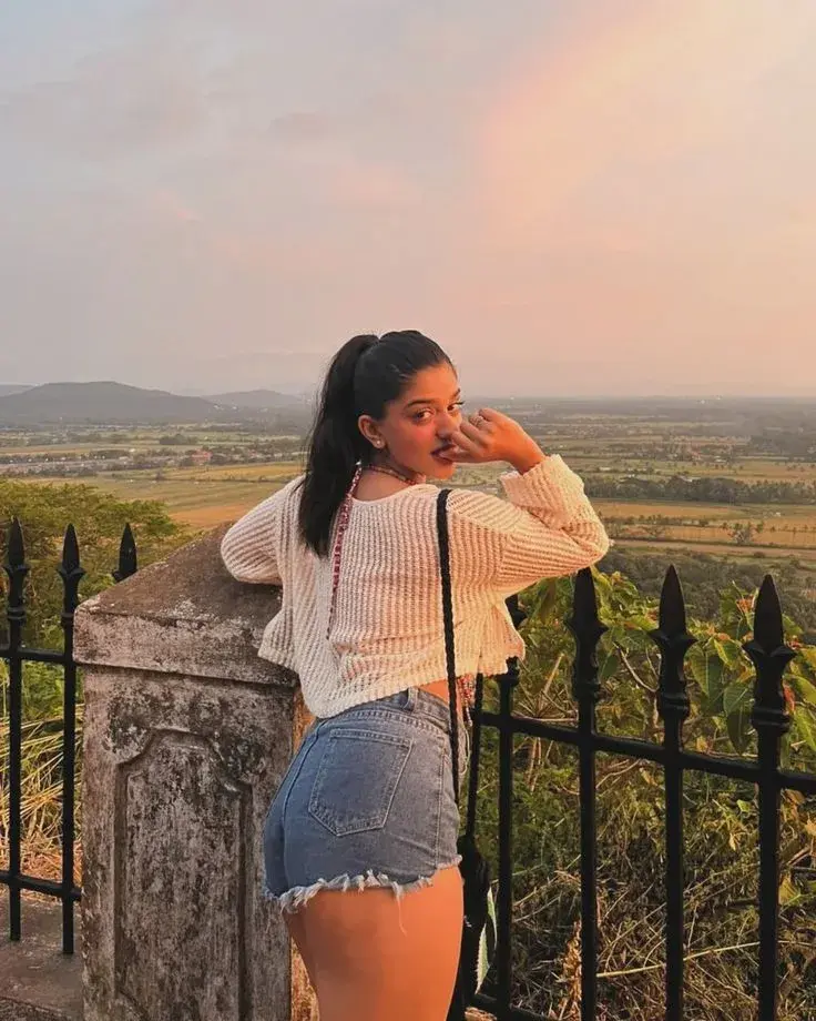 Candid Woman In Cropped Knit Sweater At Scenic Sunset Hilltop Overlook