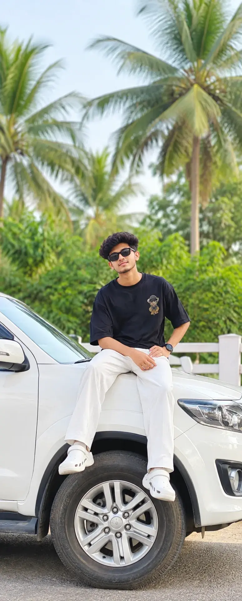 😎 Casual Streetwear Portrait Of A Young Man Sitting On A White Suv In A Lush Green Palm Setting 🌴 Cinematicportrait