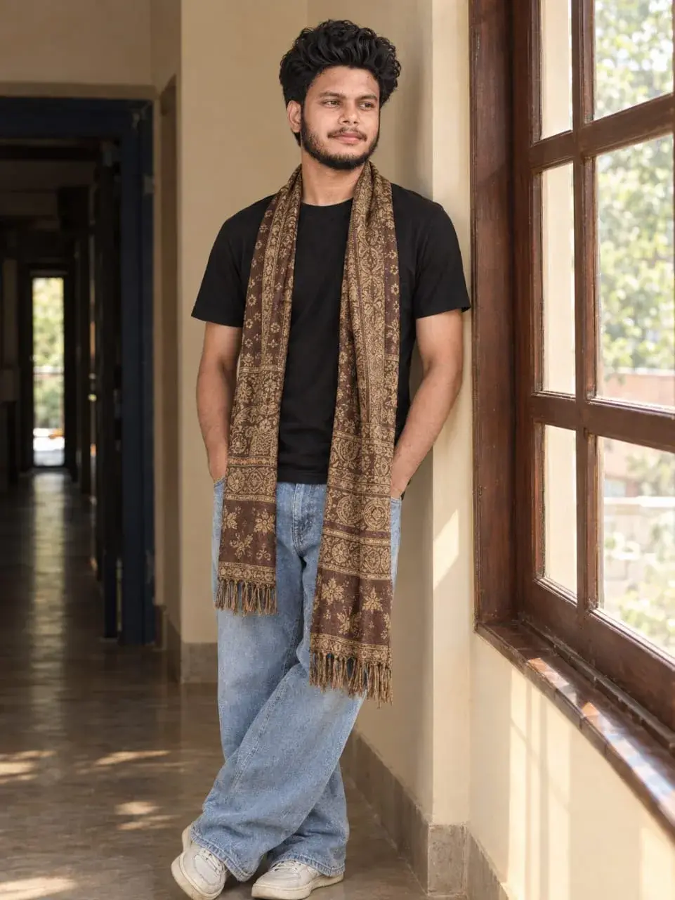 Casual Young Man In Patterned Scarf Leaning By Hallway Window