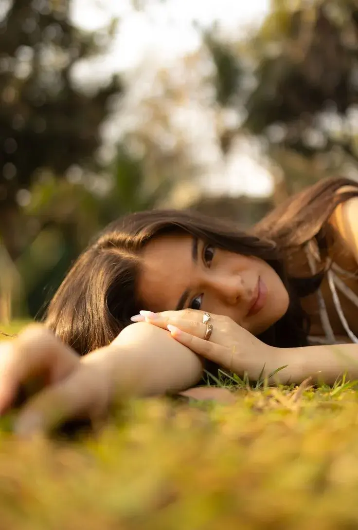 Dreamy Low-Angle Golden Hour Outdoor Portrait Of Indian Woman Lying On Grass