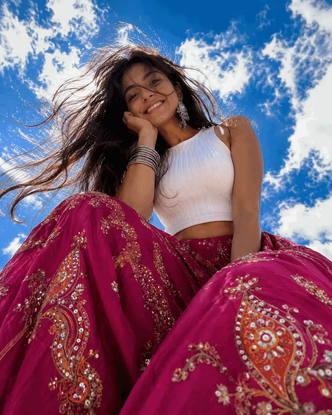 Girl In Magenta Lehenga Under Blue Sky