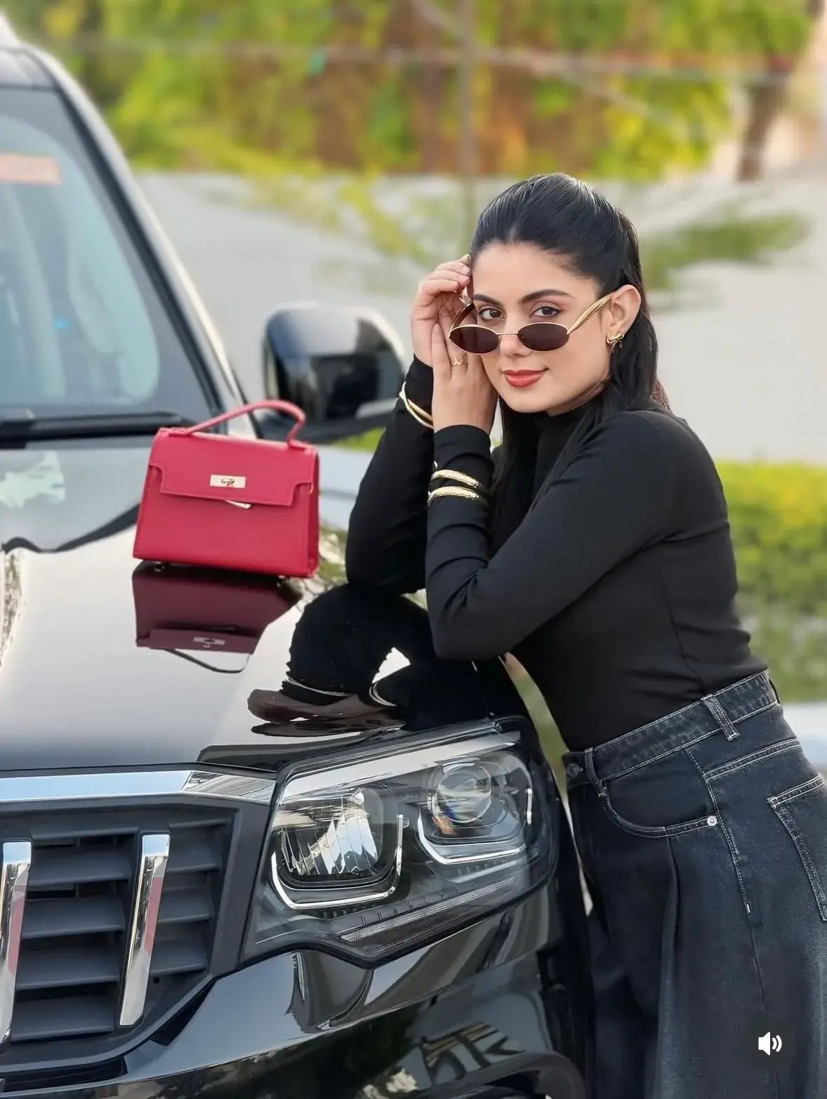 “Luxury Suv Hood Pose – Black Outfit & Red Bag”