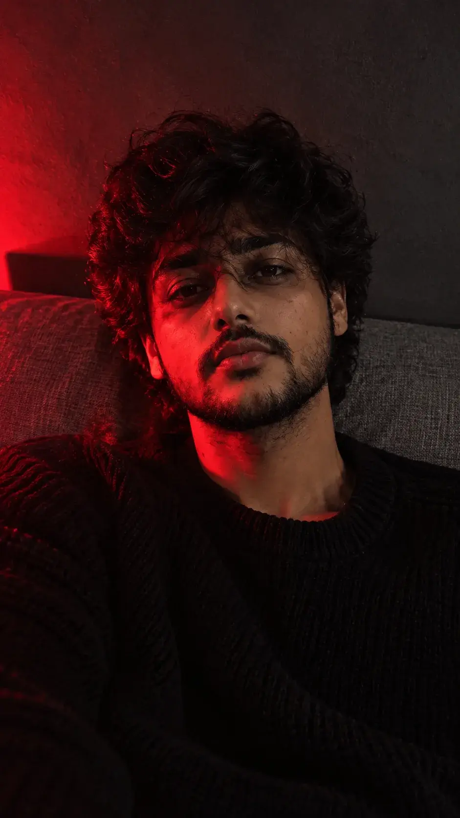 Moody Red-Light Couch Portrait.