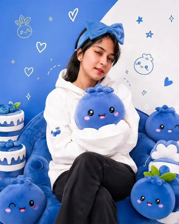 Playful Blueberry Cozy Aesthetic: Young Woman With Plushies And Hairbow