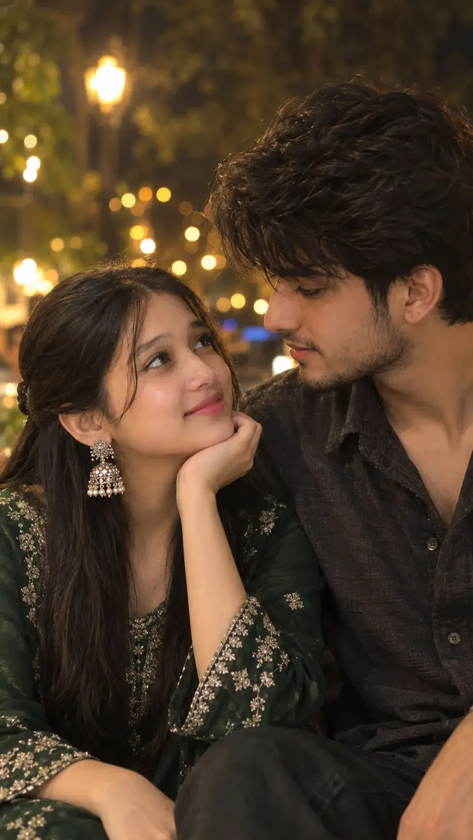 Romantic Young South Asian Couple Looking At Each Other Under Night Lights