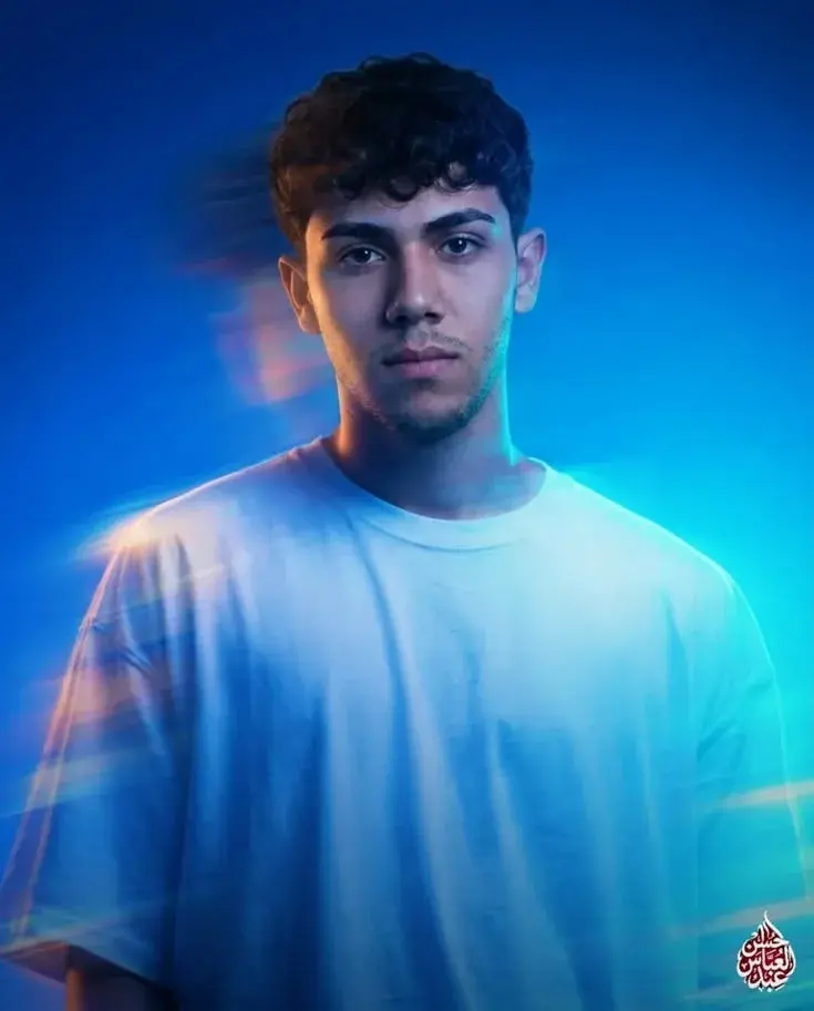 Studio Waist-Up Portrait Of Young Man With Prismatic Blue Light Trails