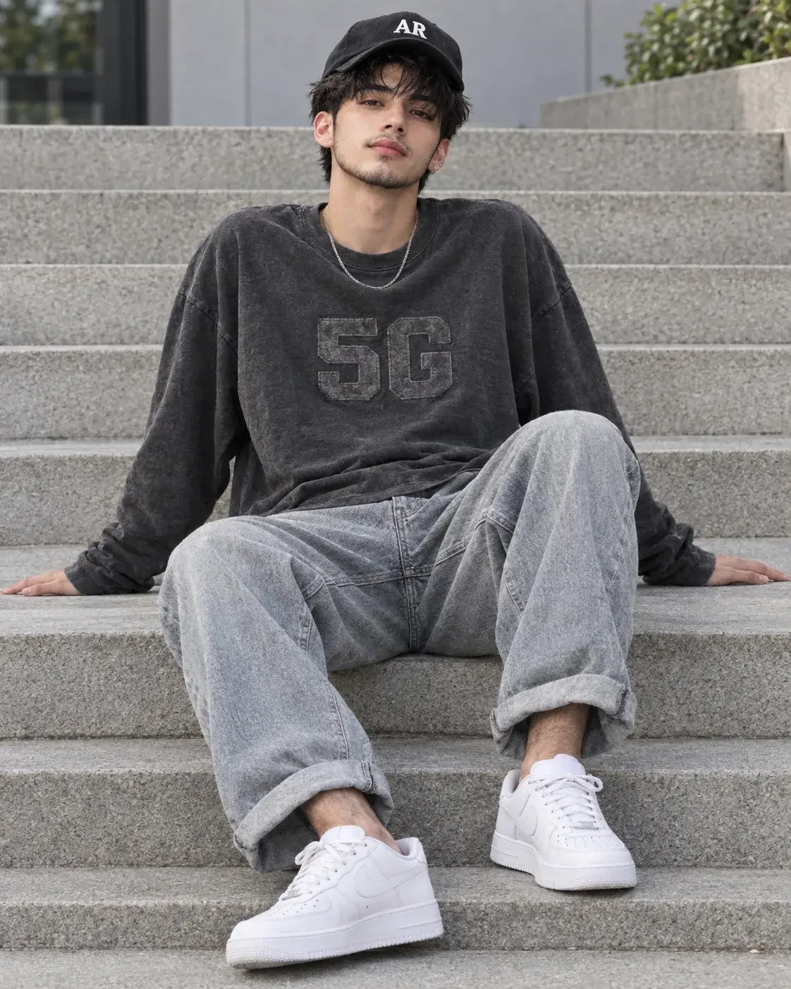 Stylish Young Man In 5g Sweatshirt And Cap Sitting On Concrete Steps