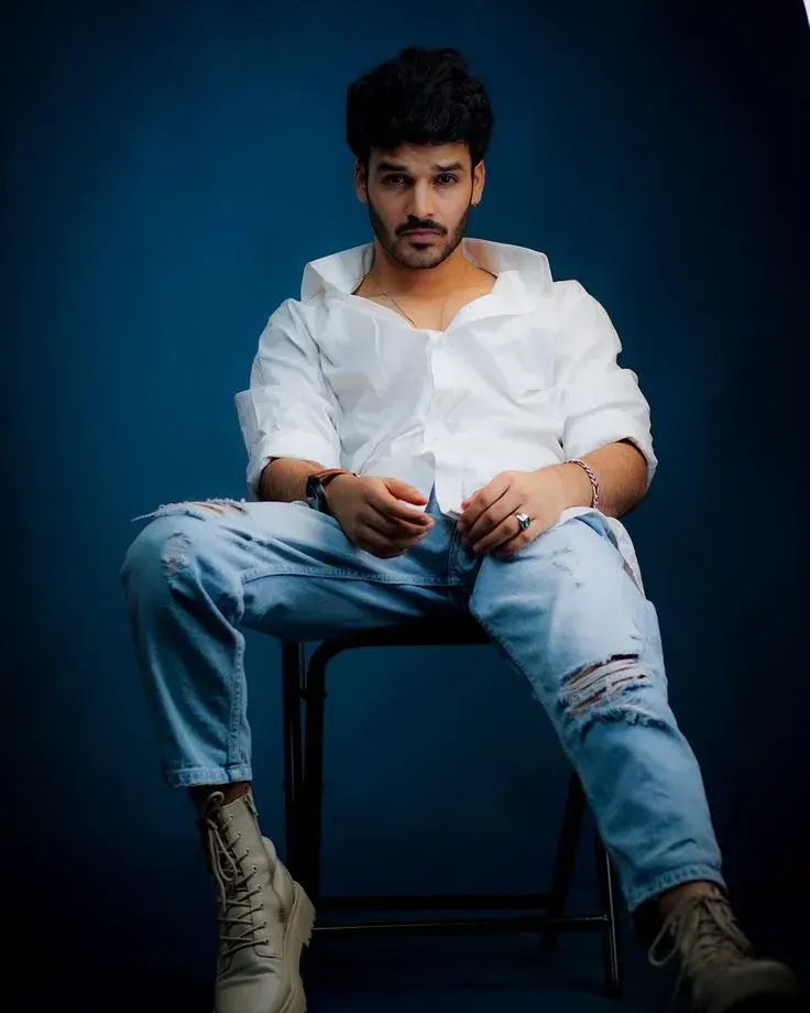 Urban Male Studio Portrait In Open White Shirt On Deep Blue Backdrop