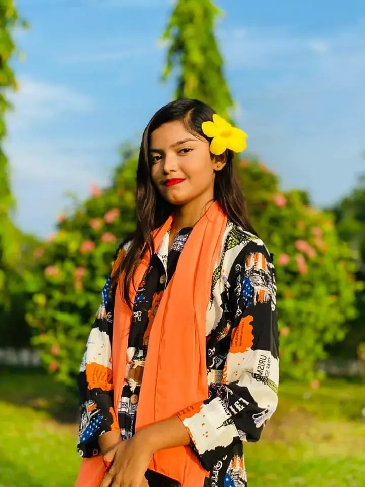 Vibrant Outdoor Garden Portrait Of Young Woman With Yellow Flower