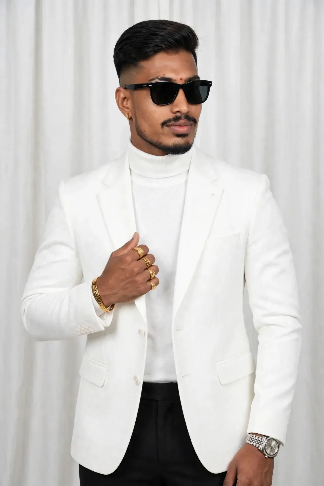 White Blazer Suit, White High-Neck Turtleneck, Black Pants, Luxury Black Sunglasses, Right Hand ಅಲ್ಲಿ Gold Bracelet + 3