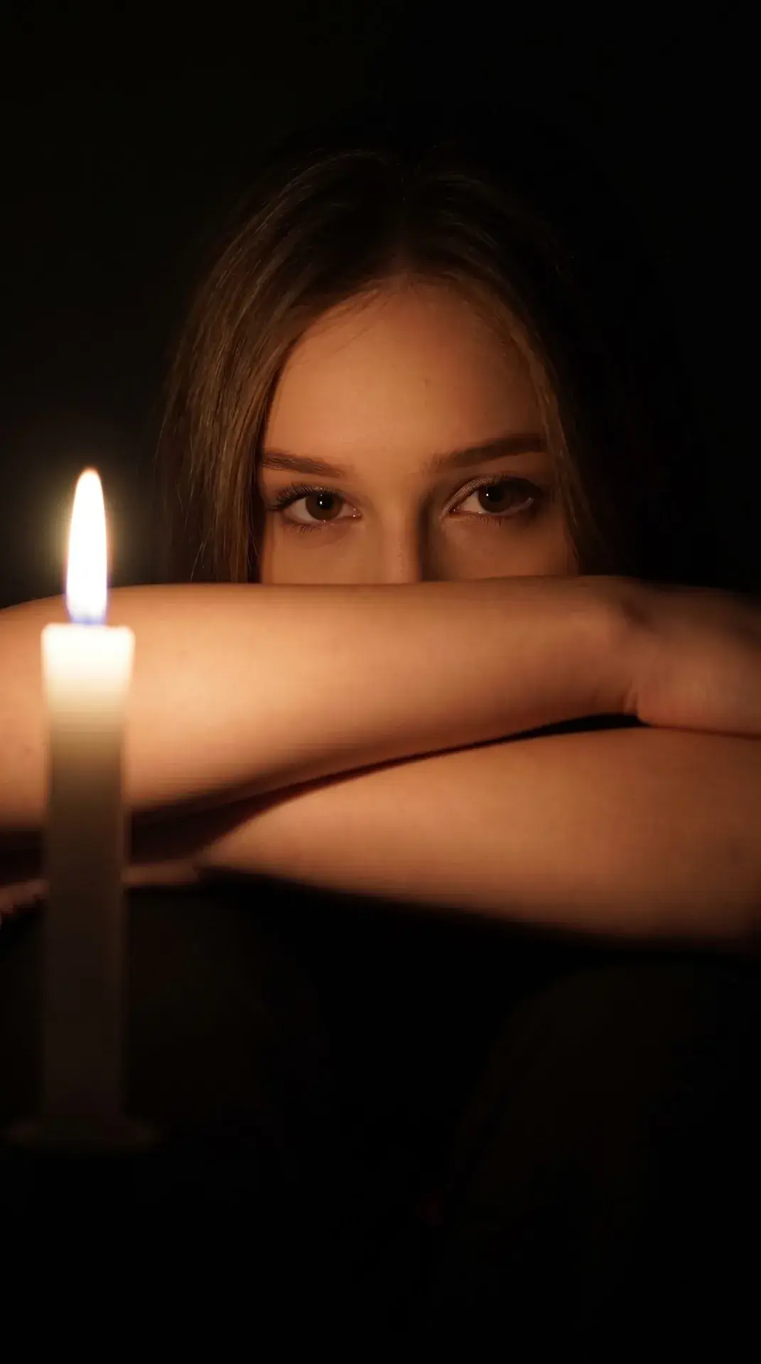 Woman Sitting By Candle