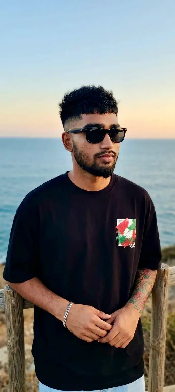 Young Man With Tattoos By The Coastal Railing