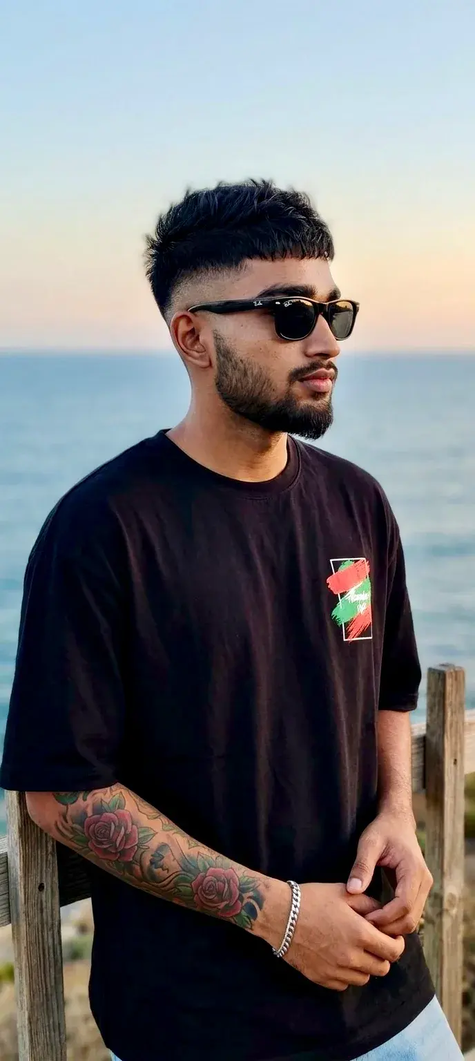 Young Man With Tattoos By The Coastal Railing
